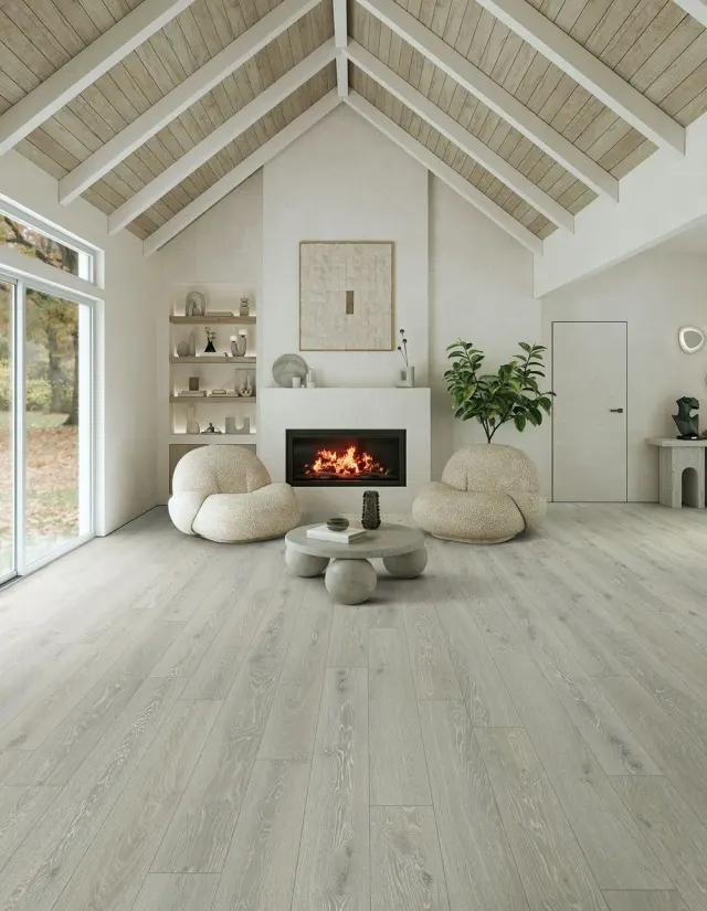 Vaulted-ceiling living room with a fireplace and light wood-look flooring.