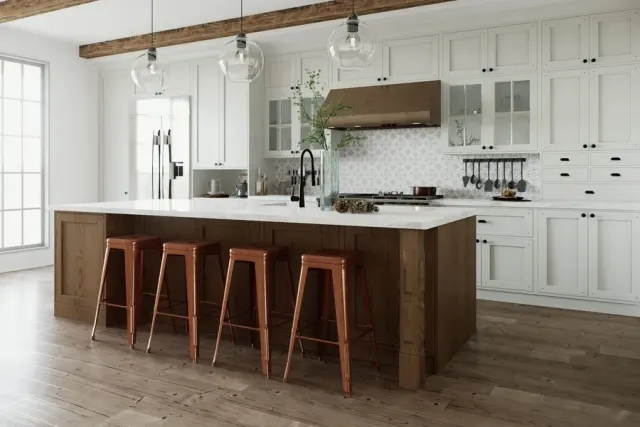 White kitchen with copper stools and warm wood-look plank flooring.